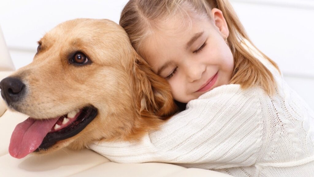 Girl hugging her pet dog