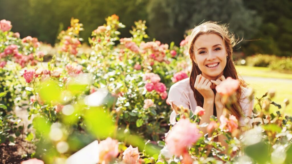 Happy woman in rose garden